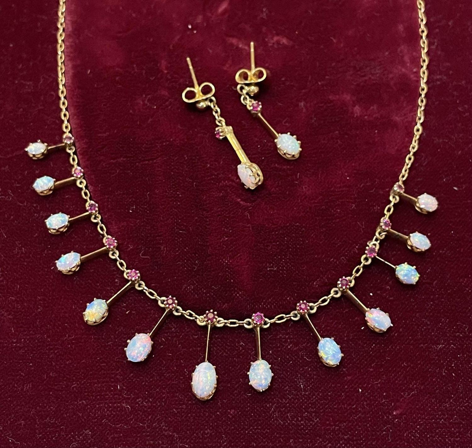 An opal and ruby fringe necklace with matching drops, from the cabinet.